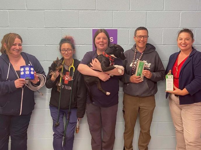 photograph of BARCS staff receiving equipment donation from AIV Vet